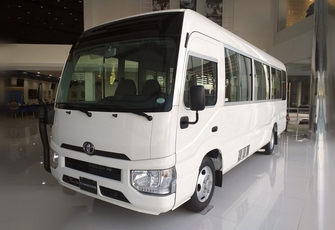 White Toyota Coaster bus