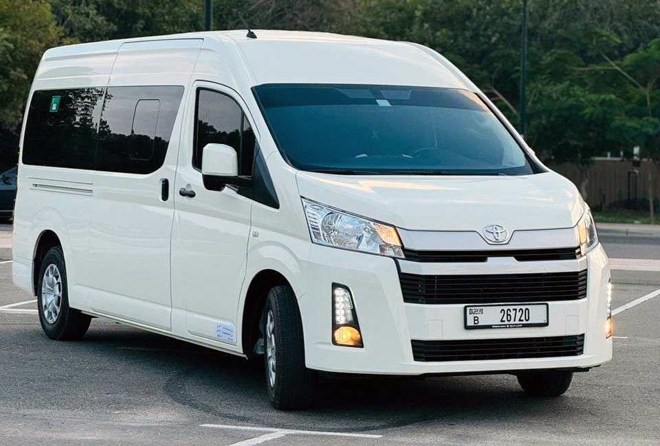 White Toyota HiAce high-roof passenger van