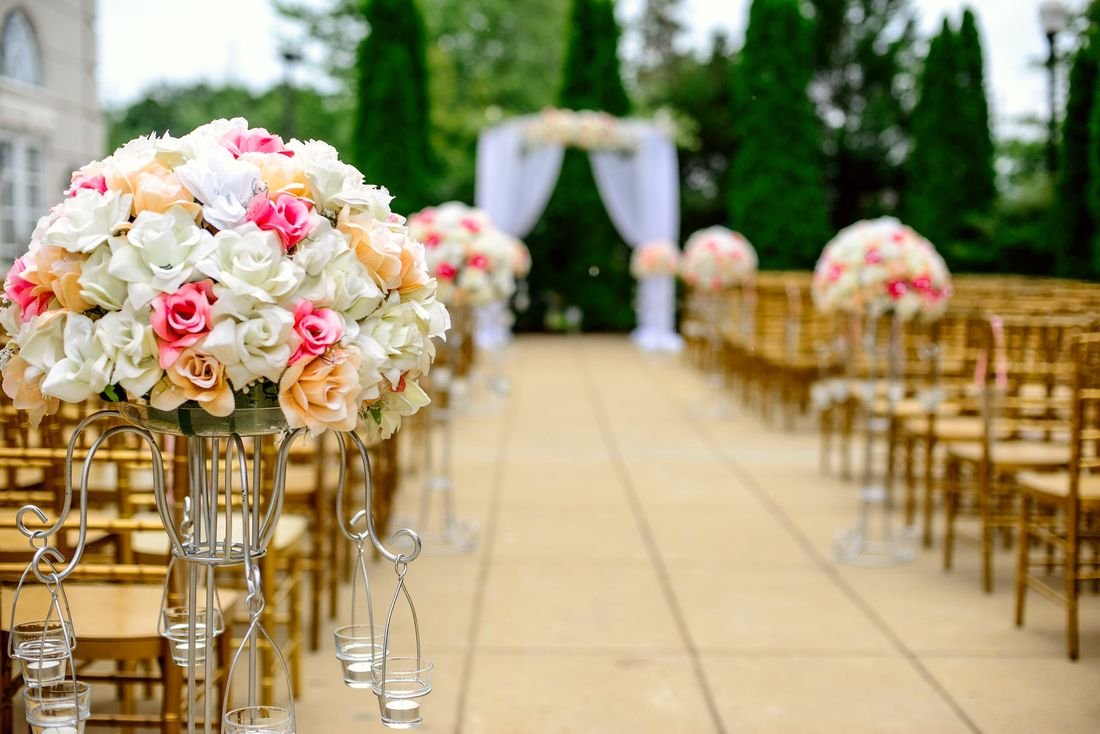 Wedding aisle lined with flowers and chairs